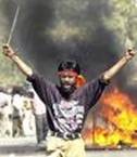 A fanatic Hindu in Ahmadabad burning Muslims