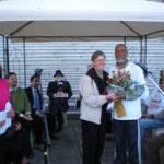 Sheila Flood presents a bouquet to Imam Soharwardy upon the completion of the Multifaith Walk Against Violence at the B.C. Legislature