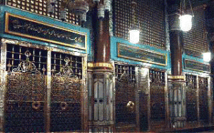 Muwajeh Sharif (Golden Grill). Behind this grill, from left to right is the Mazar-e-Mubarak of Hadhrat Muhammad (Peace be upon him) then first Caliph of Islam, Ameer ul Mo'mineen Hadhrat Abu Bakr's Mazar and after that is the Mazar of second Caliph of Islam, Ameer ul Mo'mineen, Hadhrat Umar Farooq (May Allah be pleased with them). Behind the right most grill is the empty space for one grave. It is believed that Prophet Jesus Christ (Peace be upon him) will be buried here.  (Muslims believe that Allah has raised Jesus Christ towards Heavens. Jesus is alive and one day will return to the world.)